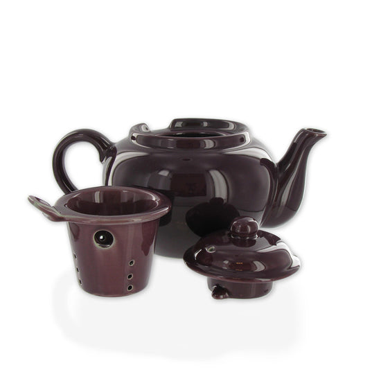 Teapot with lid off and on the side with the tea infuser all on a white background