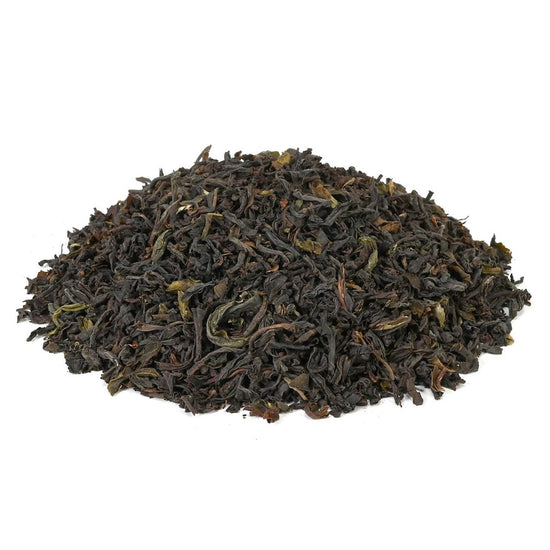 Heap of loose-leaf black tea on a white background