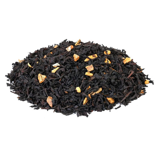 Heap of loose-leaf black tea with dried fruit pieces mixed in