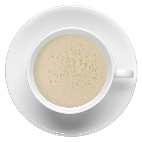 White cup with a hot foamy layer on top of hot liquid on a white background