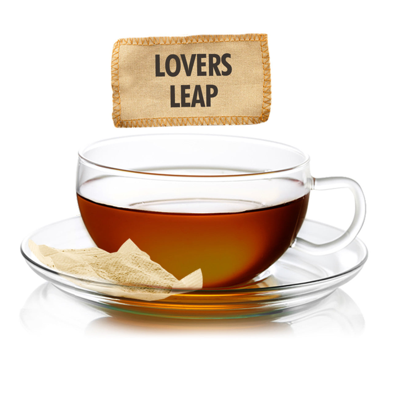 Glass teacup featuring amber colored Lovers Leap tea with a teabag on the side and a label on the top displaying tea name.