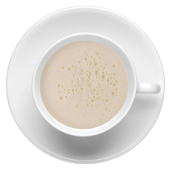 Top-down view of white forth top layer of hot matcha tea in a white cup on a white background