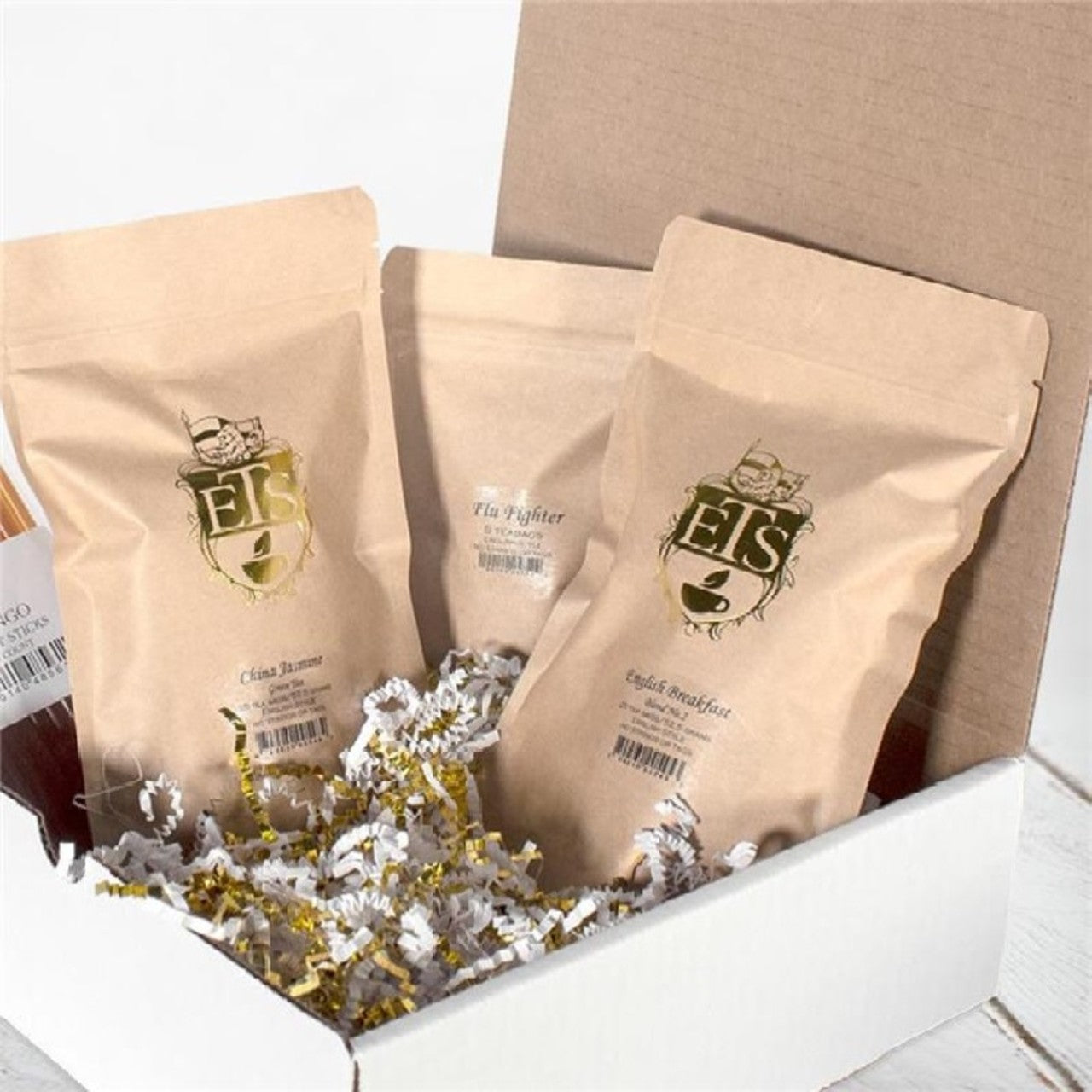 Three brown bags with a logo on a white surface