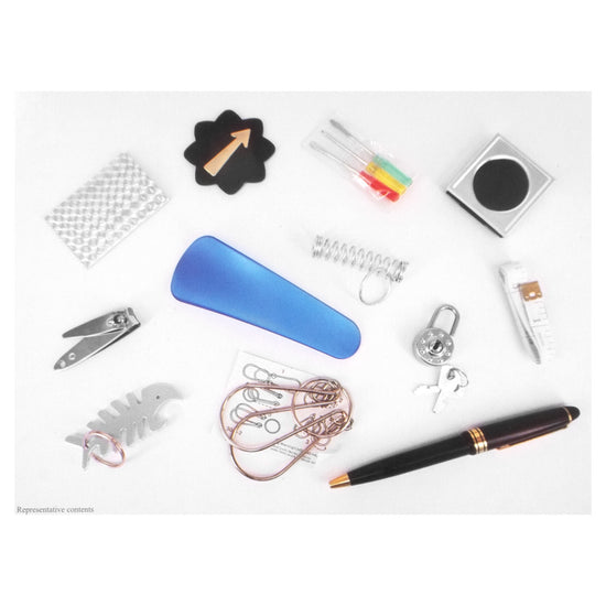 Party favor contents for Pudding Lane Christmas crackers on a white background featuring nail clippers, a pen, a mini screwdriver set, and other items.