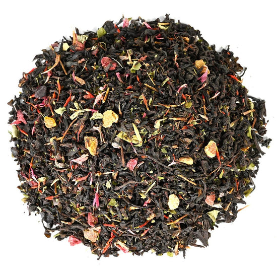 Pile of loose-leaf black tea leaves with pink and yellow flower petals mixed in.