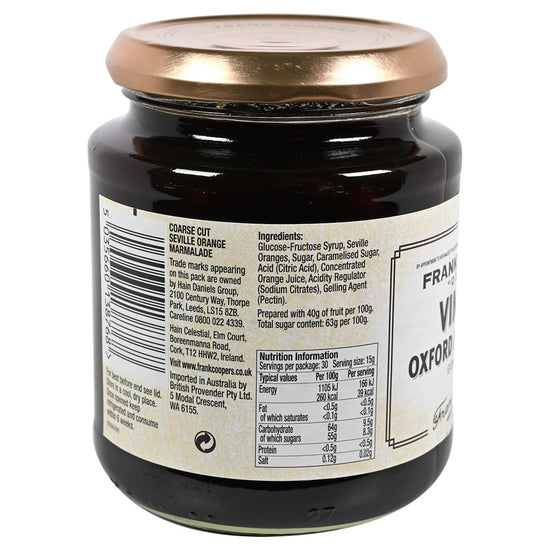 Side view of a jar of Frank Cooper's Vintage Oxford Marmalade with a gold lid on a white background. Side view of the label listing the ingredients and nutrition information.