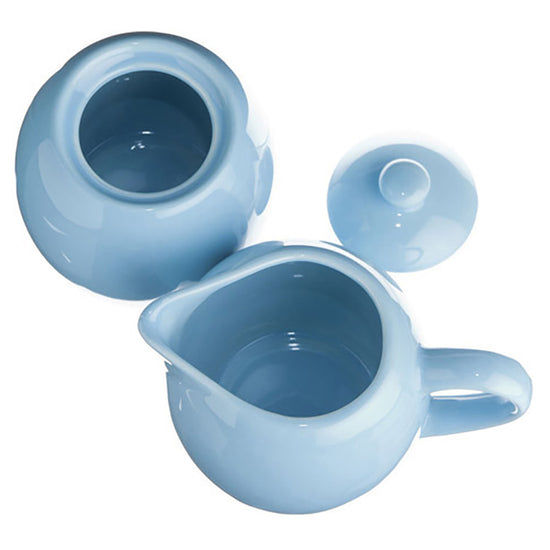 Light blue ceramic tea sugar and creamer set on a white background