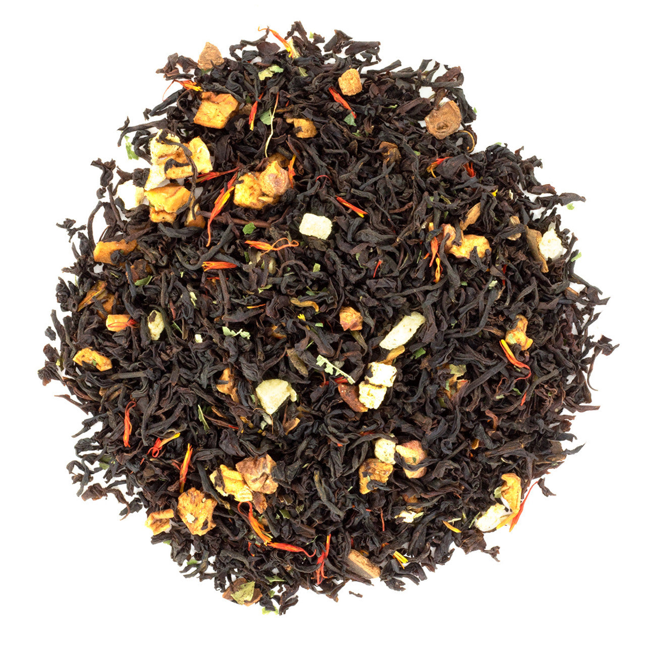 Black tea leaves with visible dried fruit and spices on a white background
