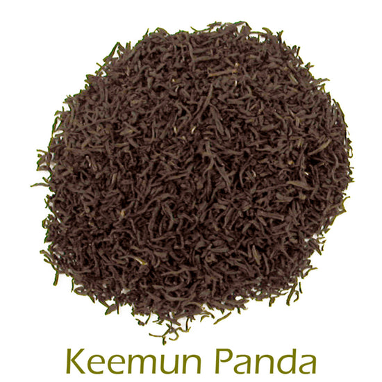 Keemun Panda loose-leaf tea in a circular pattern on a white background with product name callout at the bottom