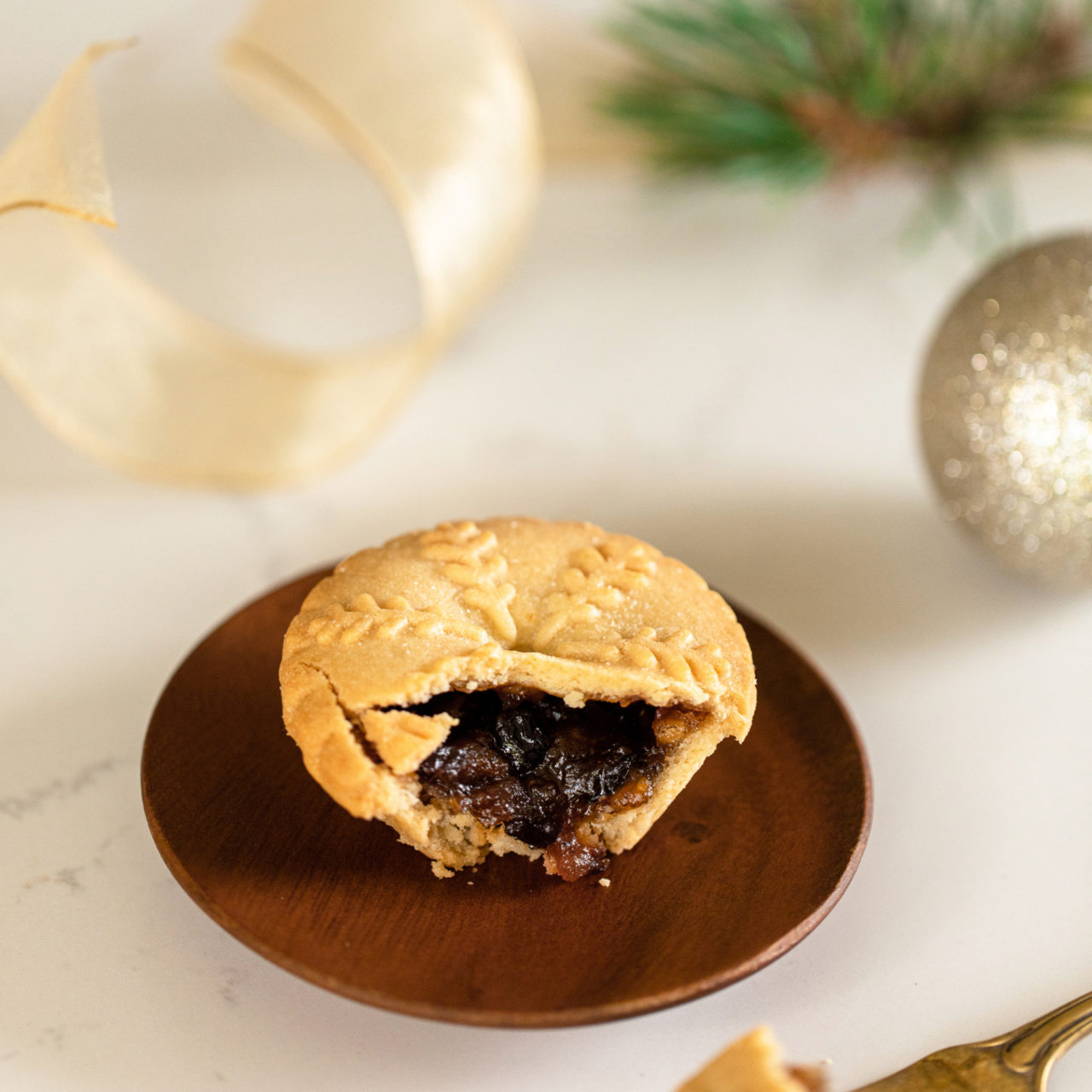 Image of a Walker's Mince Pie with a portion cut off to view the filling inside.