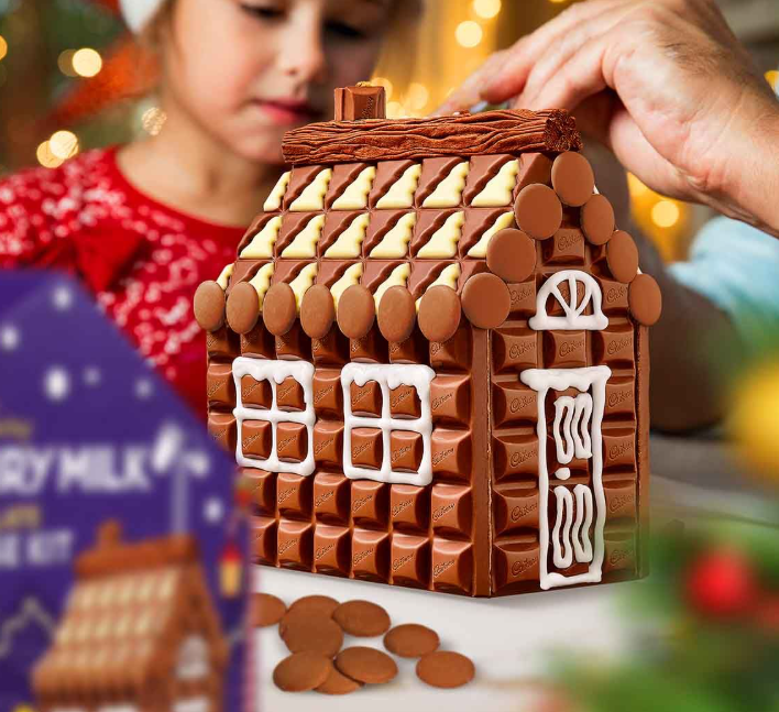 A hand building the chocolate house