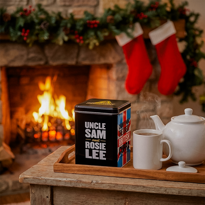 Uncle Sam Rosie Lee tea tin on a tray by a fireplace with stockings and a fire