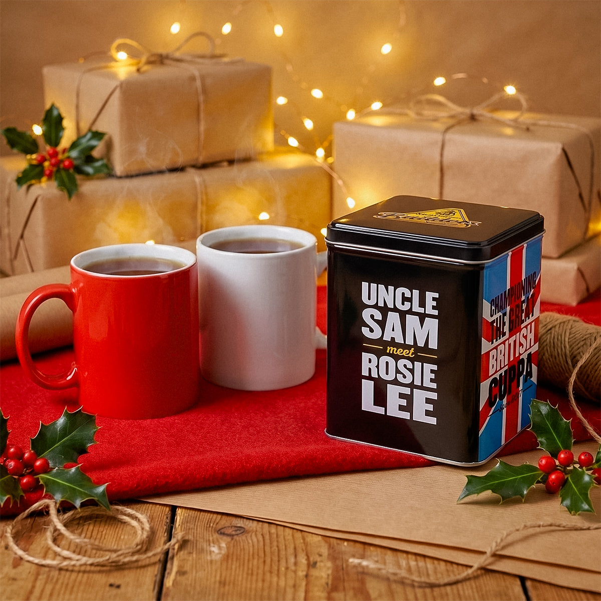 Uncle Sam Rosie Lee tea tin with mugs and wrapped gifts on a red cloth with festive lights