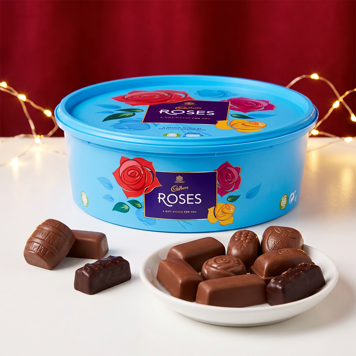 Blue Roses tub with a plate of chocolates and fairy lights behind