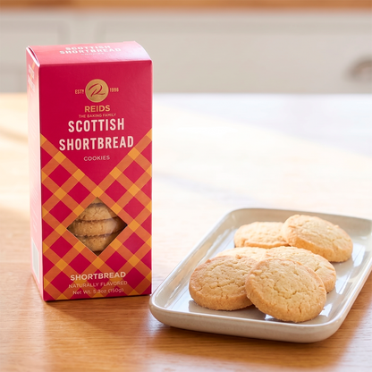 Pink and red patterned product box beside a tray of scones on a table