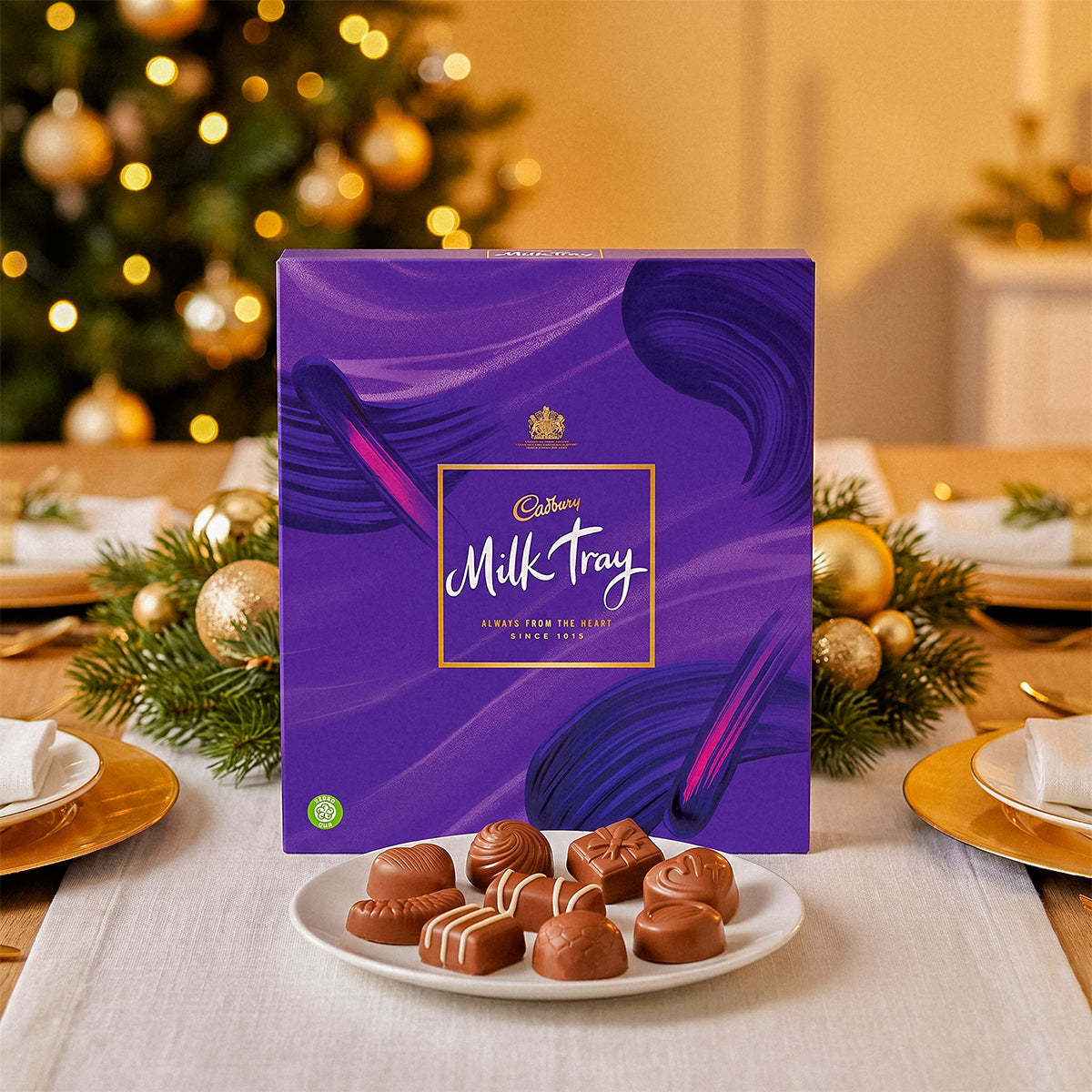 Milk Tray box with a plate of chocolates and a Christmas tree in the background