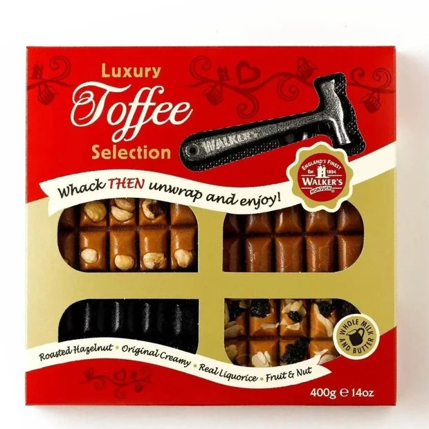 A box of Walker's Luxury Toffee Selection with visible product offering through clear plastic windows.  Features a small hammer for whacking the toffee apart.