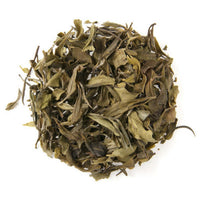Ball of green tea leaves on a white background