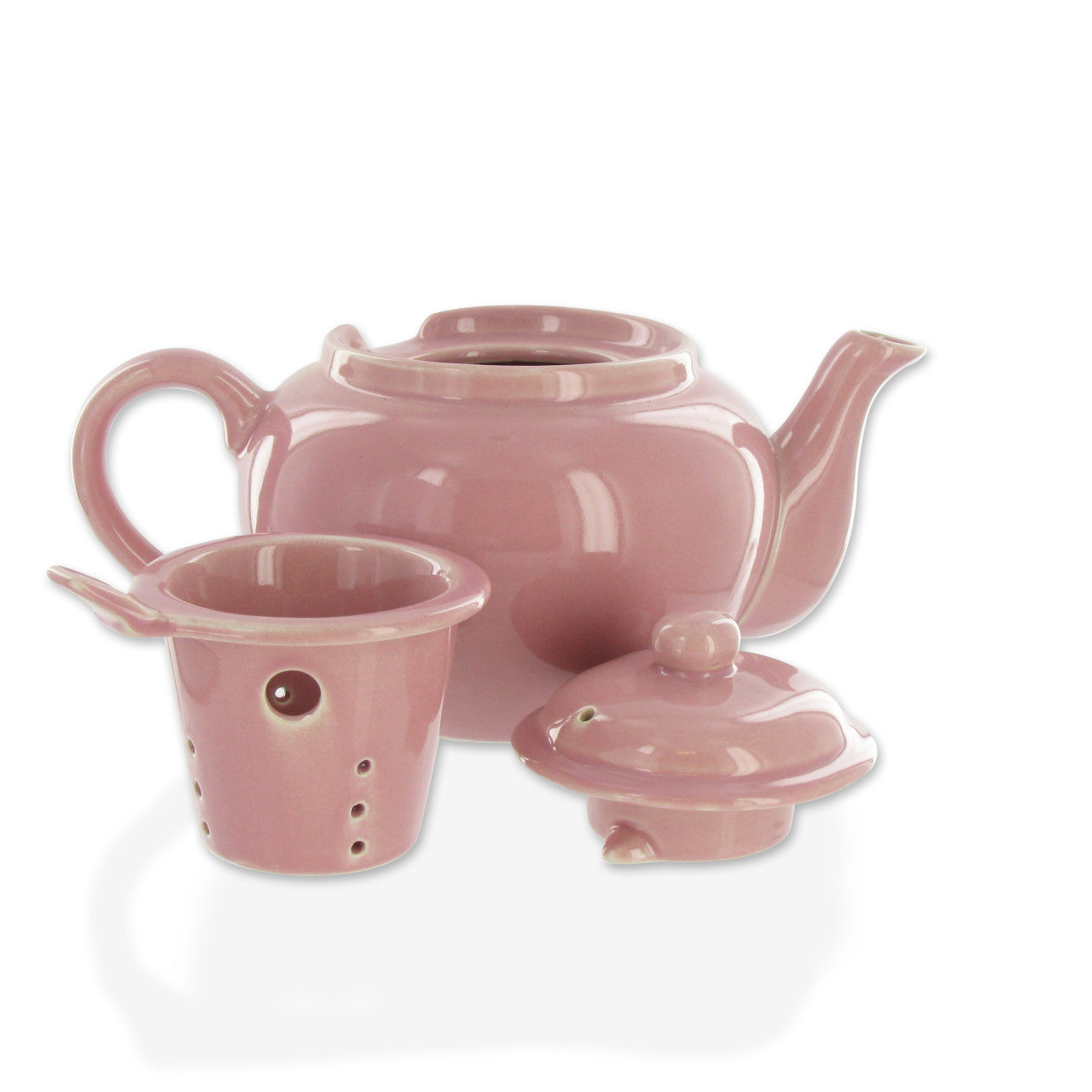 Pink ceramic teapot with lid and infuser on a white background