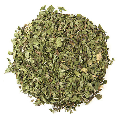 Dry green tea leaves a white background