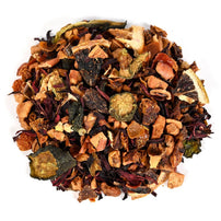 Assorted dried tea leaves, fruit pieces, and spices on a white background