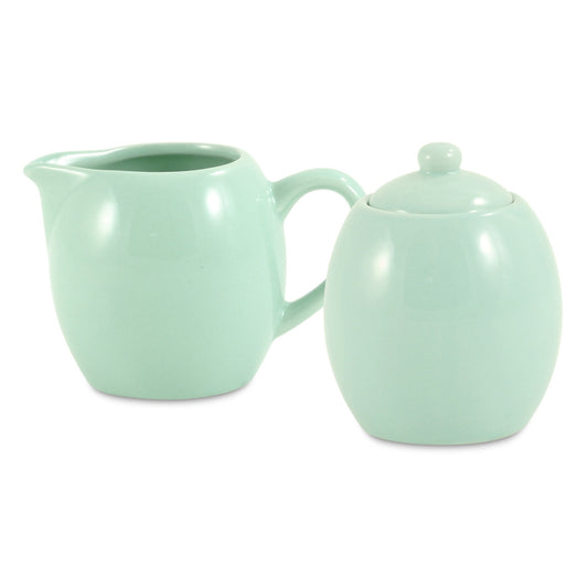 Mint green creamer and sugar bowl set on a white background