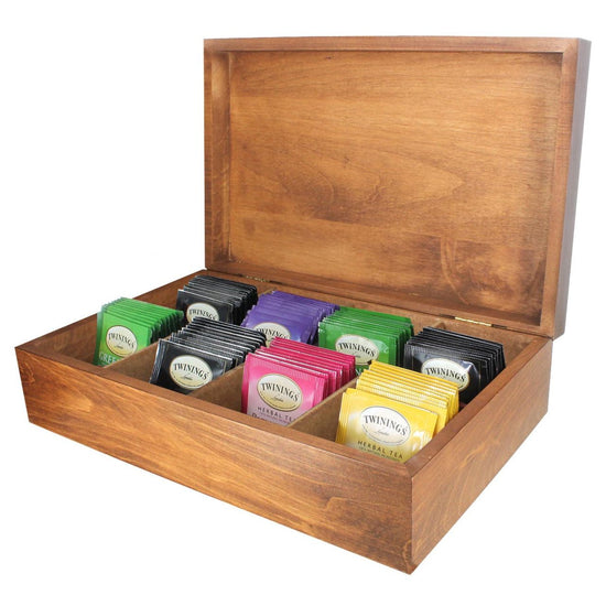 Wooden tea box opened displaying colorful individually wrapped Twinings teabags