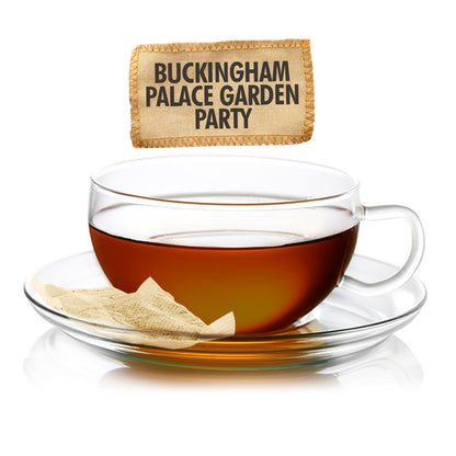 Tea cup with a tea bag labeled 'Buckingham Palace Garden Party' on a white background