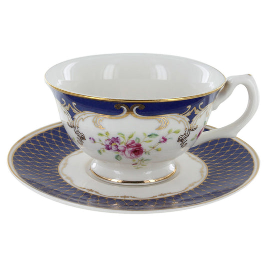 Teacup and saucer with floral design and blue rim on a white background
