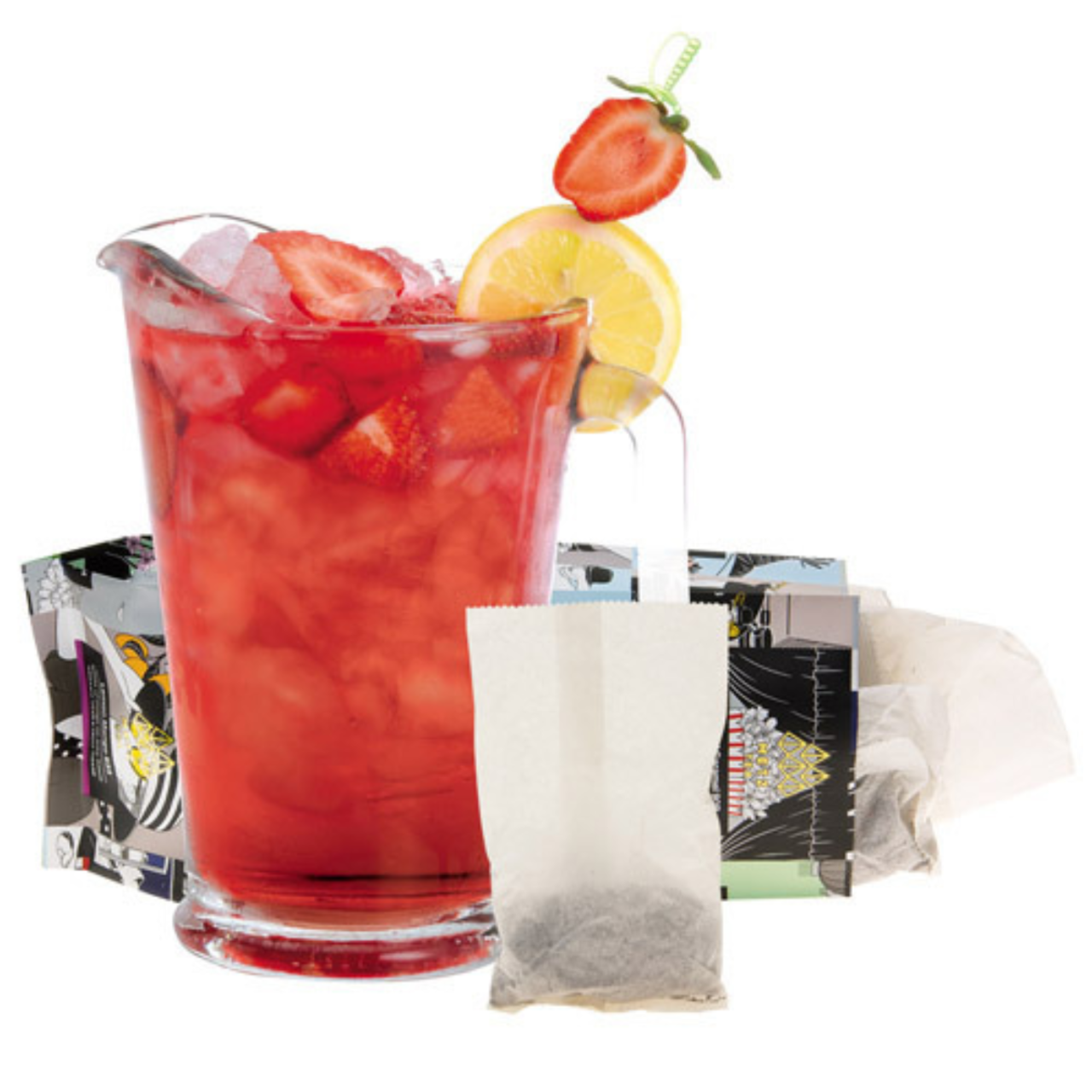 Glass pitcher of red iced tea with strawberries and lemon, with tea bags and teabags in the background.