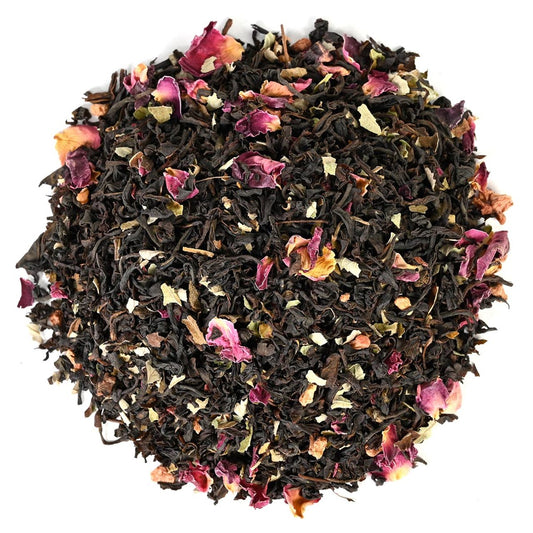 Black tea leaves with dried flowers on a white background