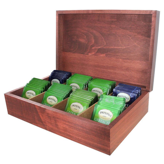A wooden tea chest with multiple compartments, each filled with individually wrapped Twinings green tea bags.