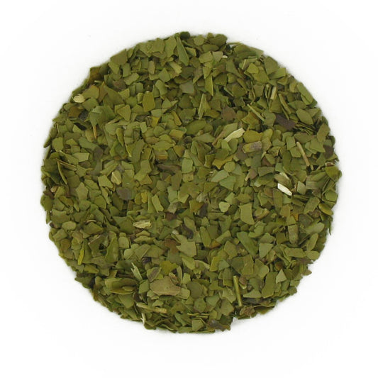 Dried green tea leaves on a white background