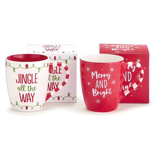 Two Christmas-themed mugs with decorative text and packaging on a white background