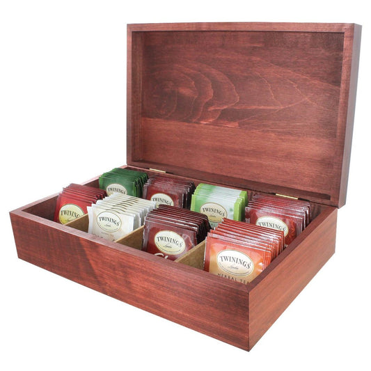 Wooden tea box opened displaying colorful individually wrapped Twinings teabags