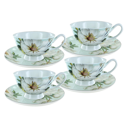 Set of four floral teacups and saucers on a white background