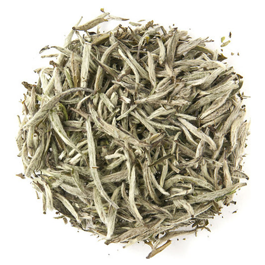 Dry tea leaves on a white background