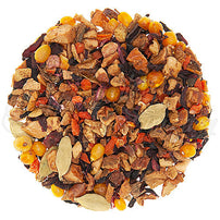 A mix of dried herbal tisane, including pieces of apple, carrot, hibiscus, and pumpkin, and whole spices such as cinnamon and cardamom, indicative of the ingredients in Pumpkin Pie Herbal Loose Leaf Tea.