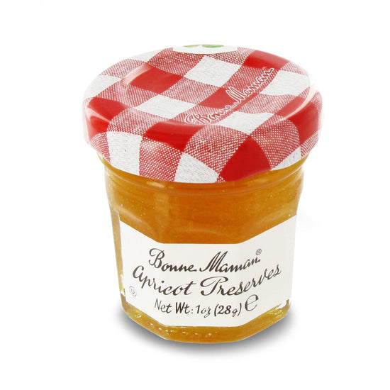 Jar of Bonne Maman Apricot Preserves with a red and white checkered lid on a white background