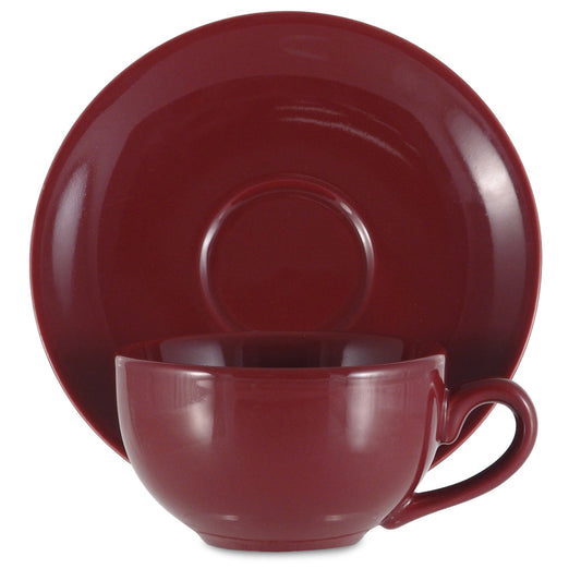 Red ceramic cup and saucer set on a white background