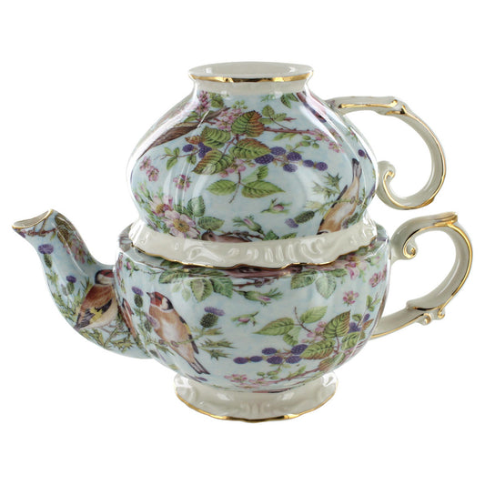 Decorative teapot with floral and bird design on a white background