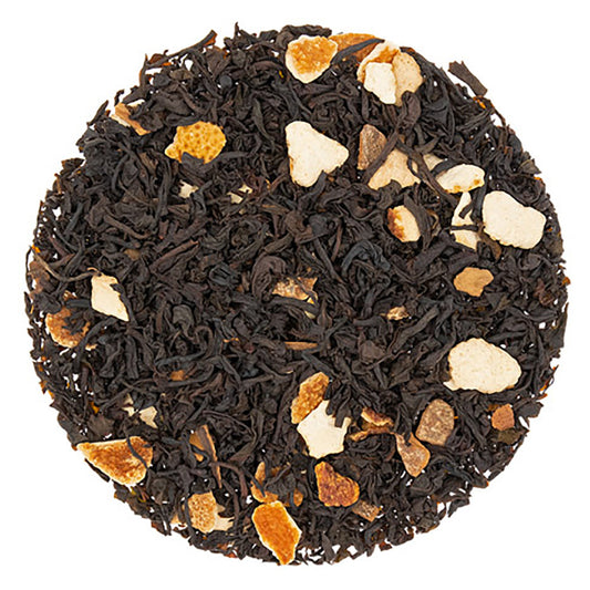 A close-up of loose leaf black tea with pieces of cinnamon and orange added to it.