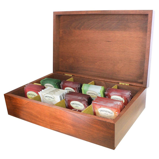 Wooden tea box opened displaying colorful individually wrapped Twinings teabags