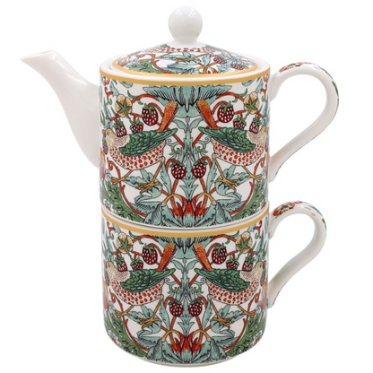 Decorative teapot stacked on a matching mug with intricate patterns on a white background